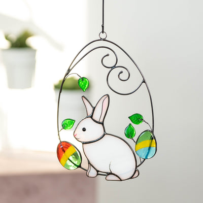 Stained glass bunny in a wired egg with two eggs on each side window hanging