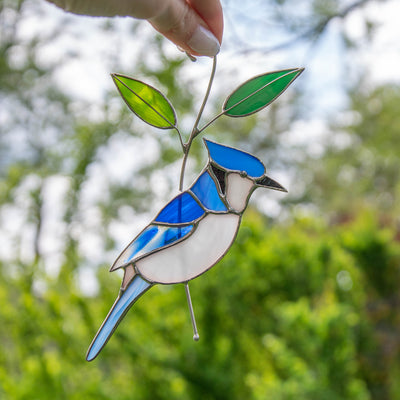 Stained glass blue jay bird on the branch suncatcher