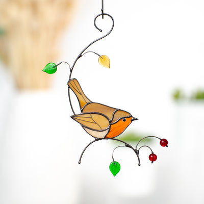 Robin bird sitting on the branch with leaves and berries window hanging of stained glass