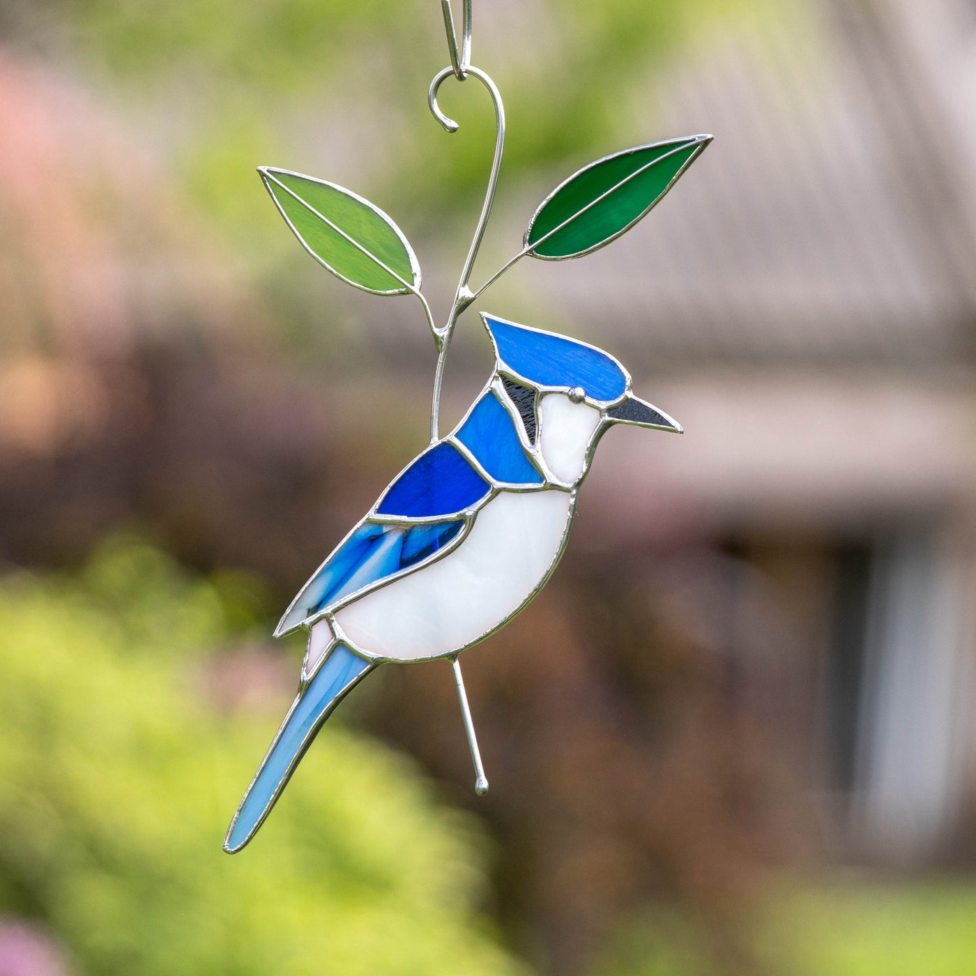 Stained glass suncatcher of blue jay bird