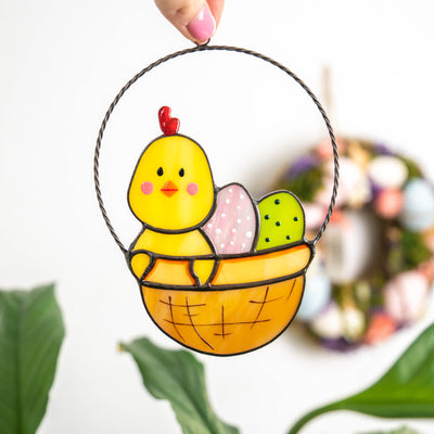 Stained glass Easter suncatcher of chick with eggs in a basket