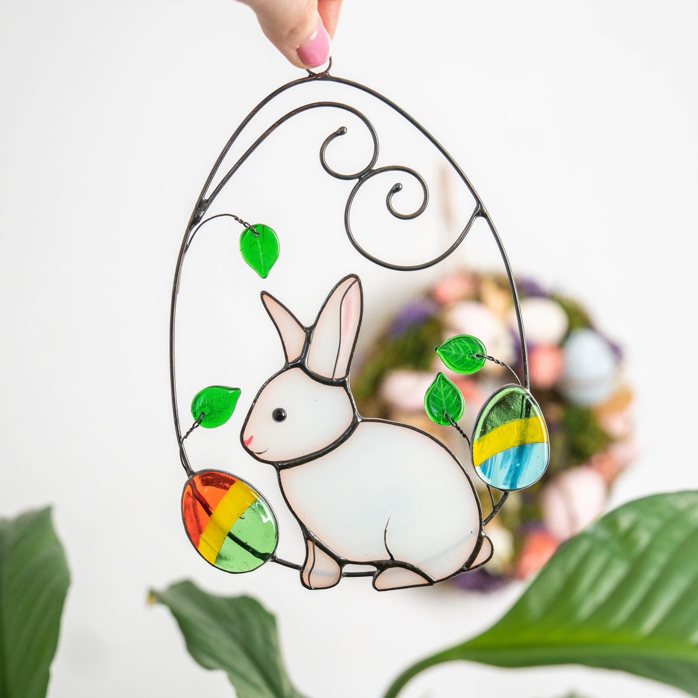 Bright bunny in a wired egg with two eggs on each side suncatcher of stained glass