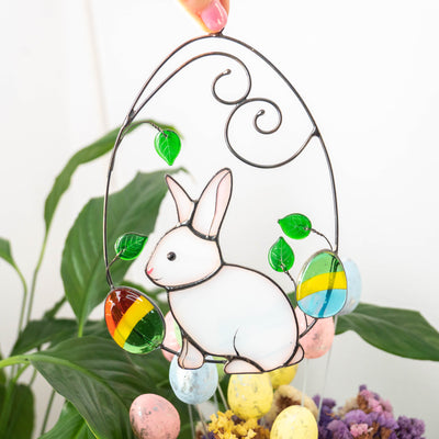 Bunny in a wired egg with two eggs on each side window hanging of stained glass