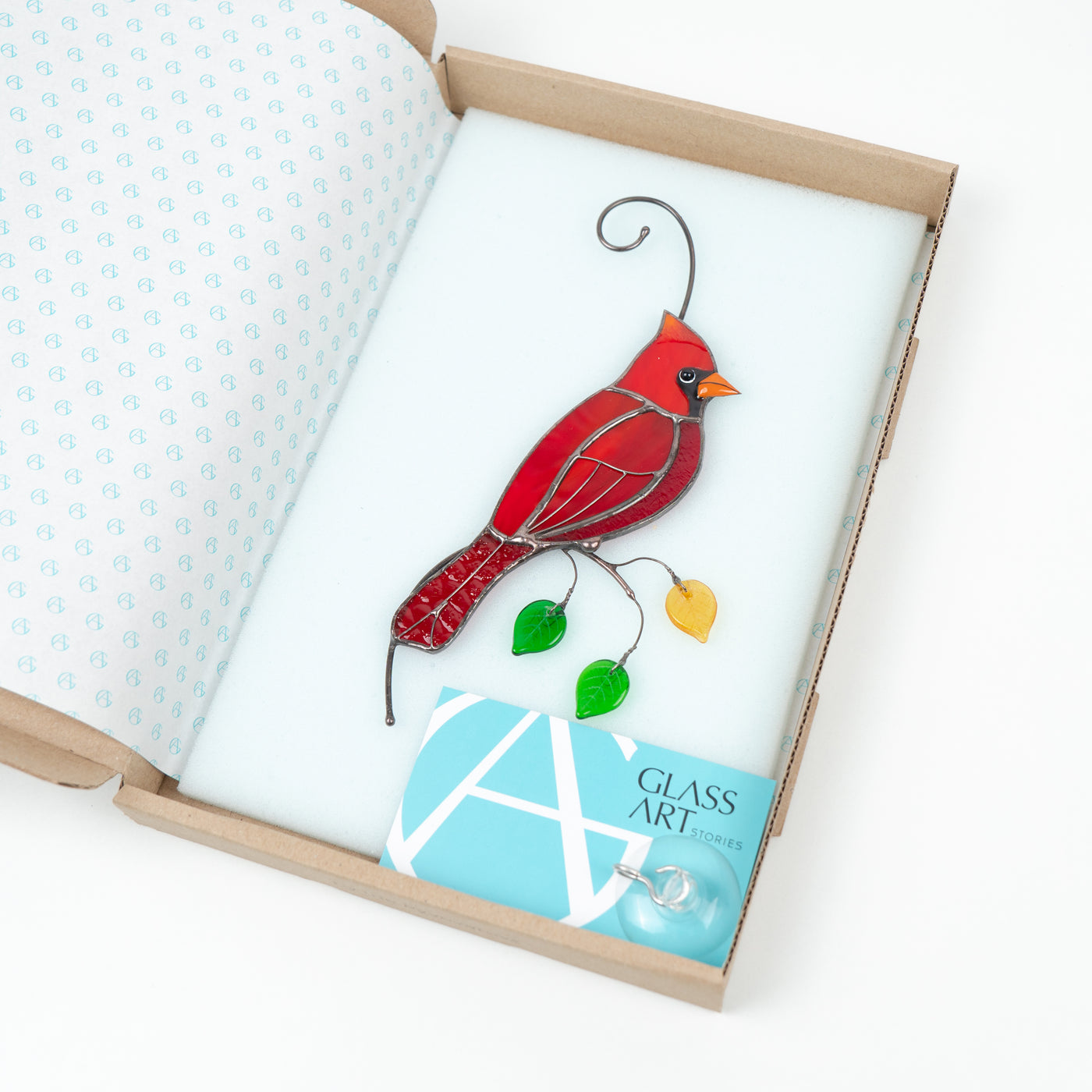 Stained glass red cardinal on the branch with leaves window hanging in a brand box