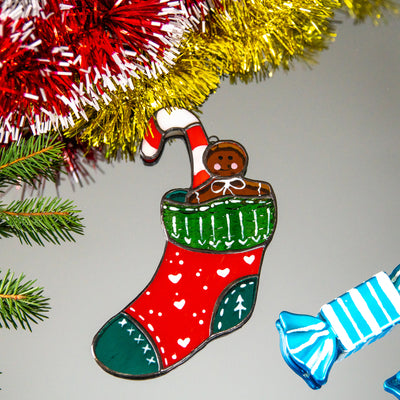 Stained glass window hanging of a Christmas stocking with candy cane 