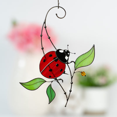 Red ladybug with leaves suncatcher of stained glass