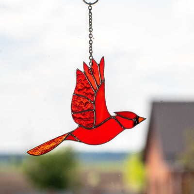 Flying red winter bird window hanging of stained glass