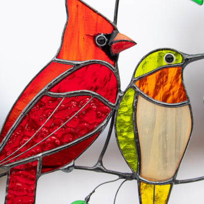 Zoomed cardinal and hummingbird of stained glass