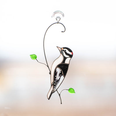 Stained glass downy woodpecker on the branch window hanging 