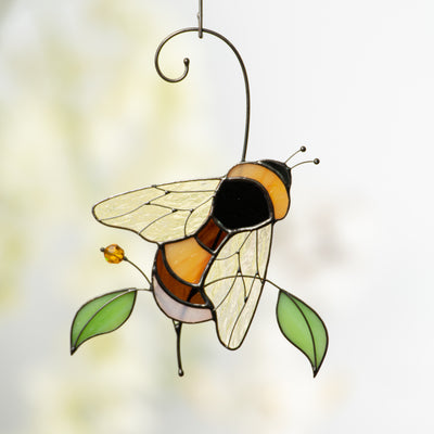 Stained glass suncatcher of a bumble bee with iridescent wings