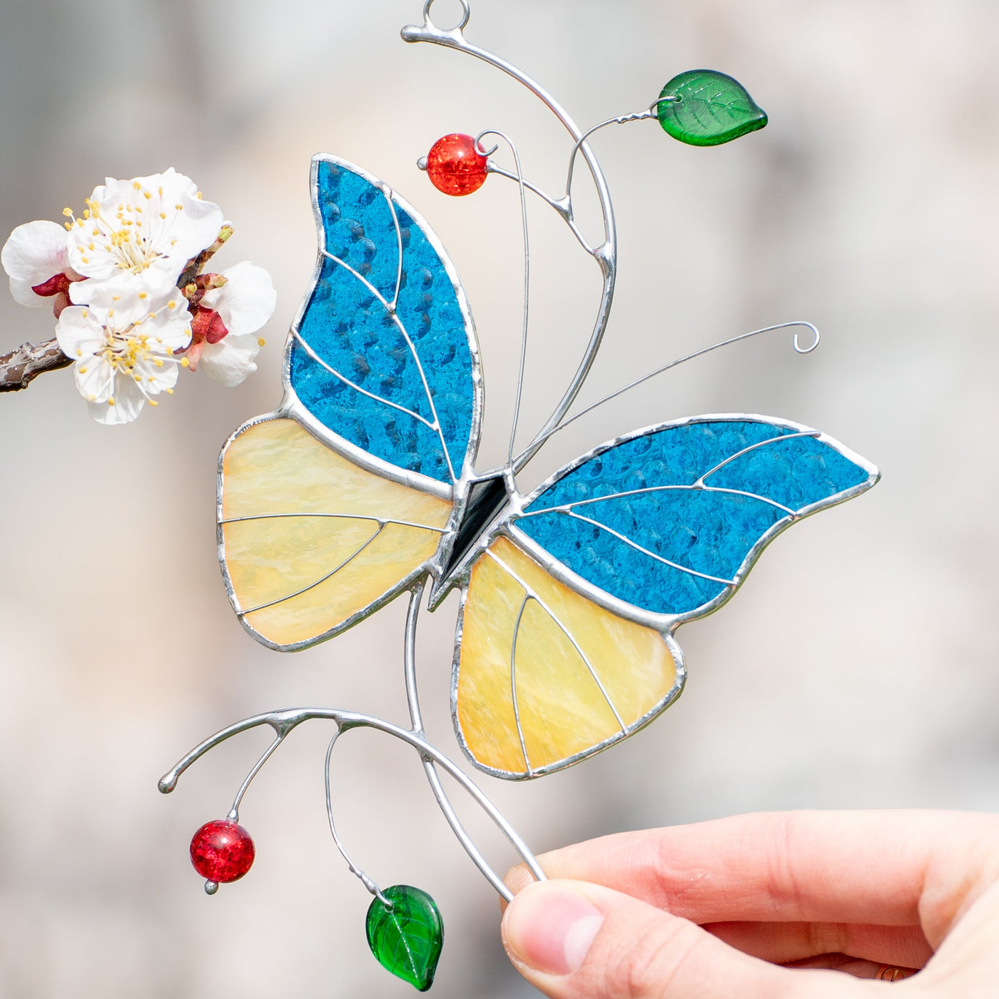 Stained glass butterfly with blue and yellow wings suncatcher