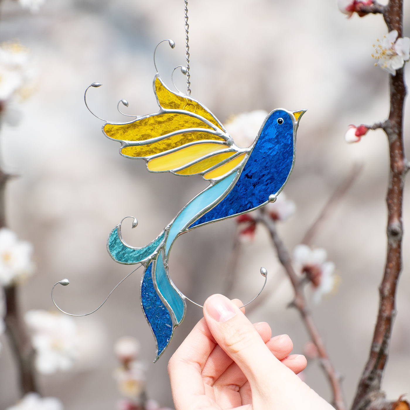 Stained glass blue bird with yellow wings suncatcher