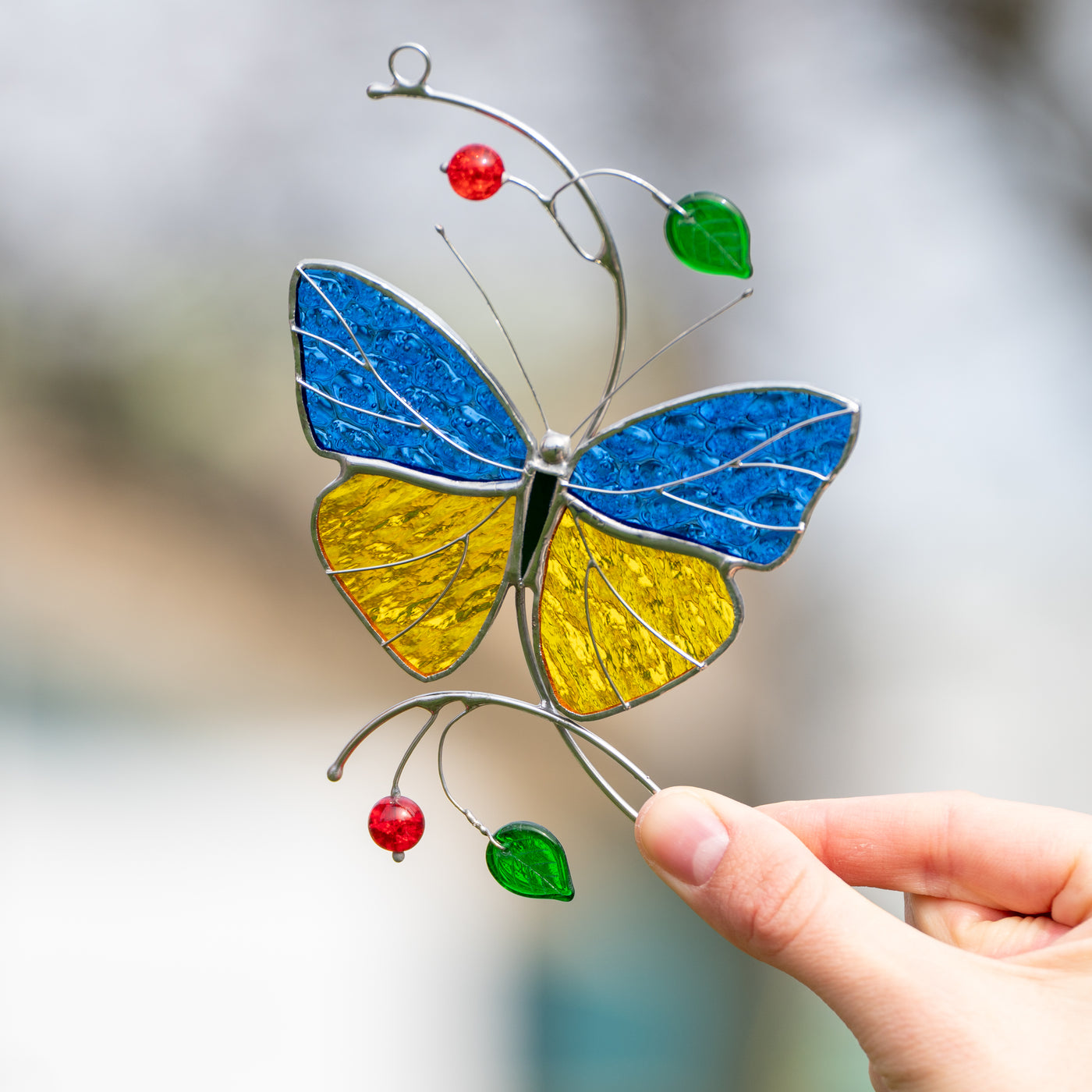 Zoomed stained glass butterfly suncatcher in Ukrainian coloring