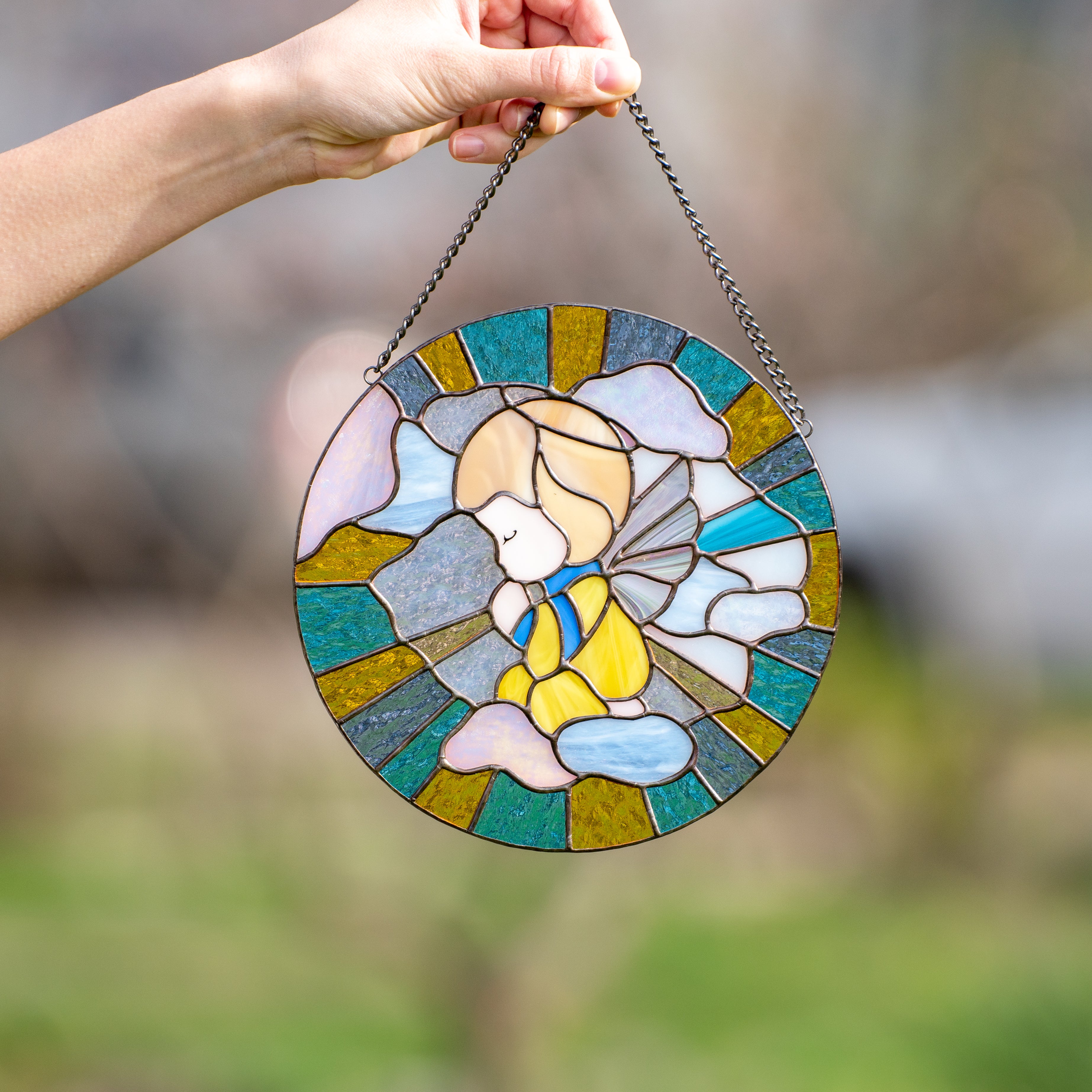  Angel on blue and yellow background depicted on stained glass window panel 