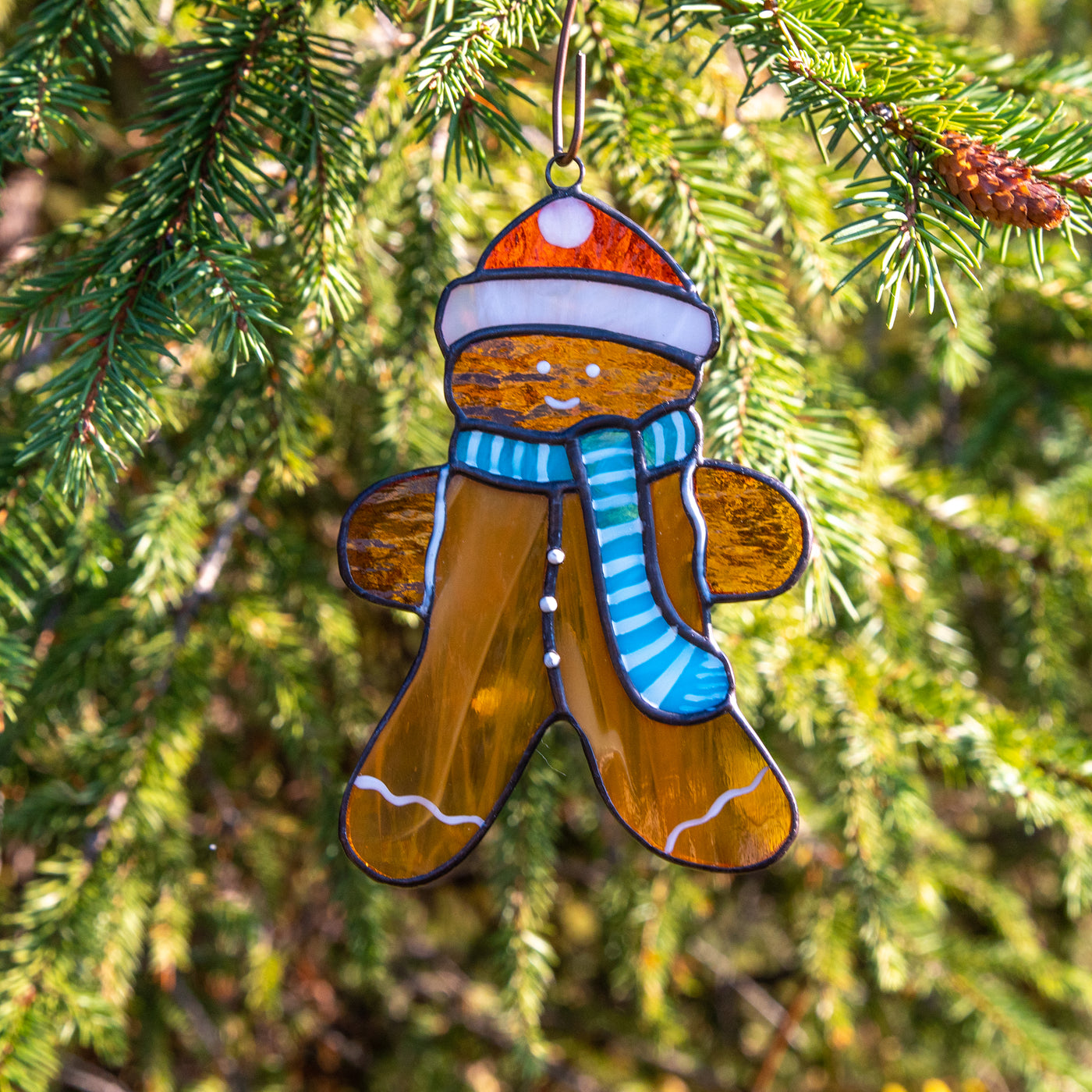 Stained glass cookie man suncatcher used as a New Year Tree decoration