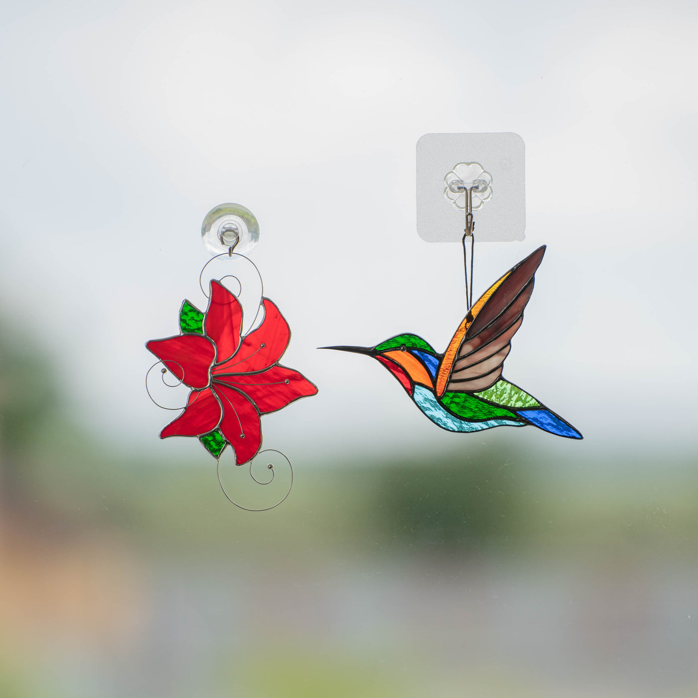 Colorful Hummingbird flying to red hibiscus made of stained glass
