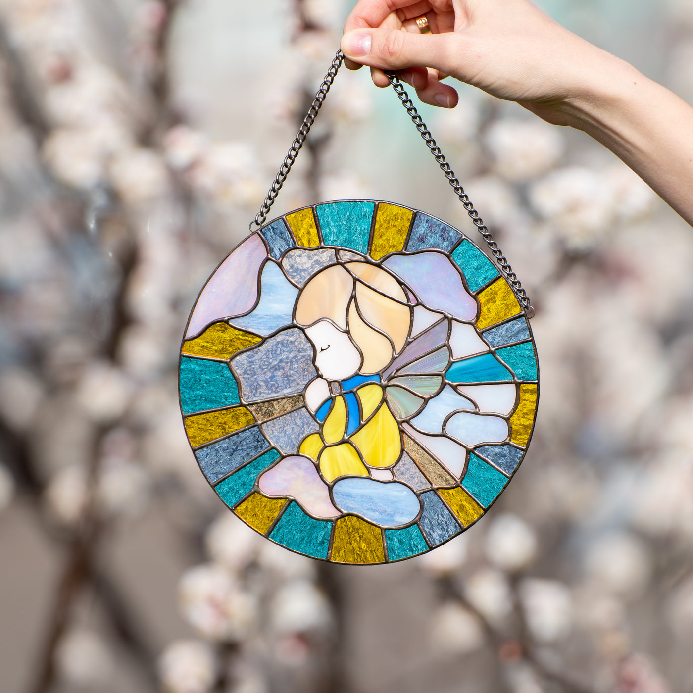 Stained glass window hanging depicting angel on Ukrainian coloured background
