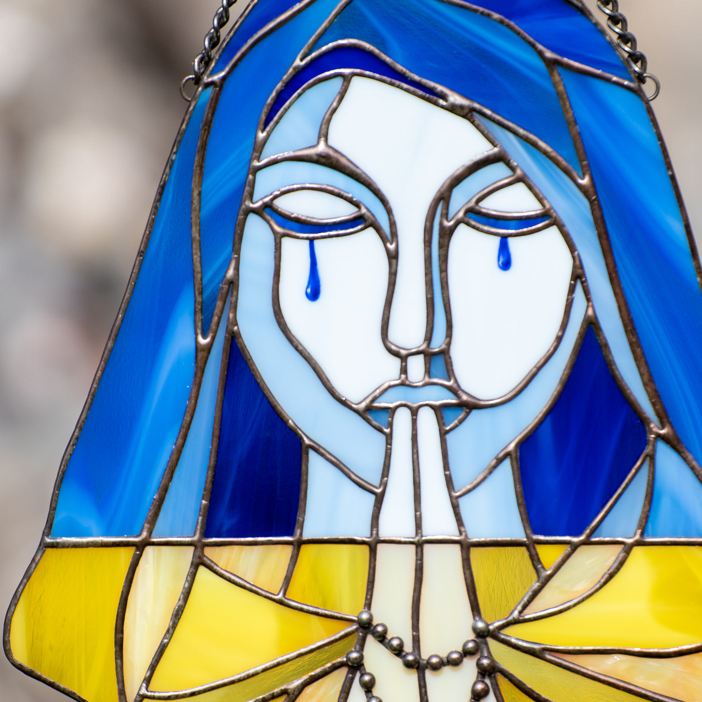 Zoomed stained glass crying Ukraine 