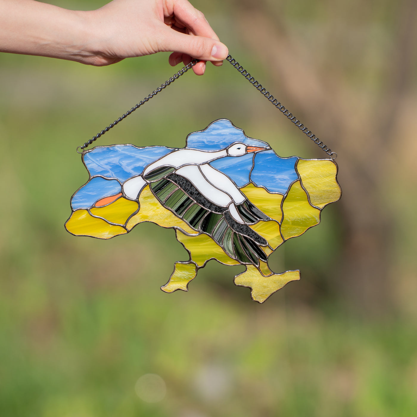 Stained glass window hanging of Ukraine with the flying stork in the middle