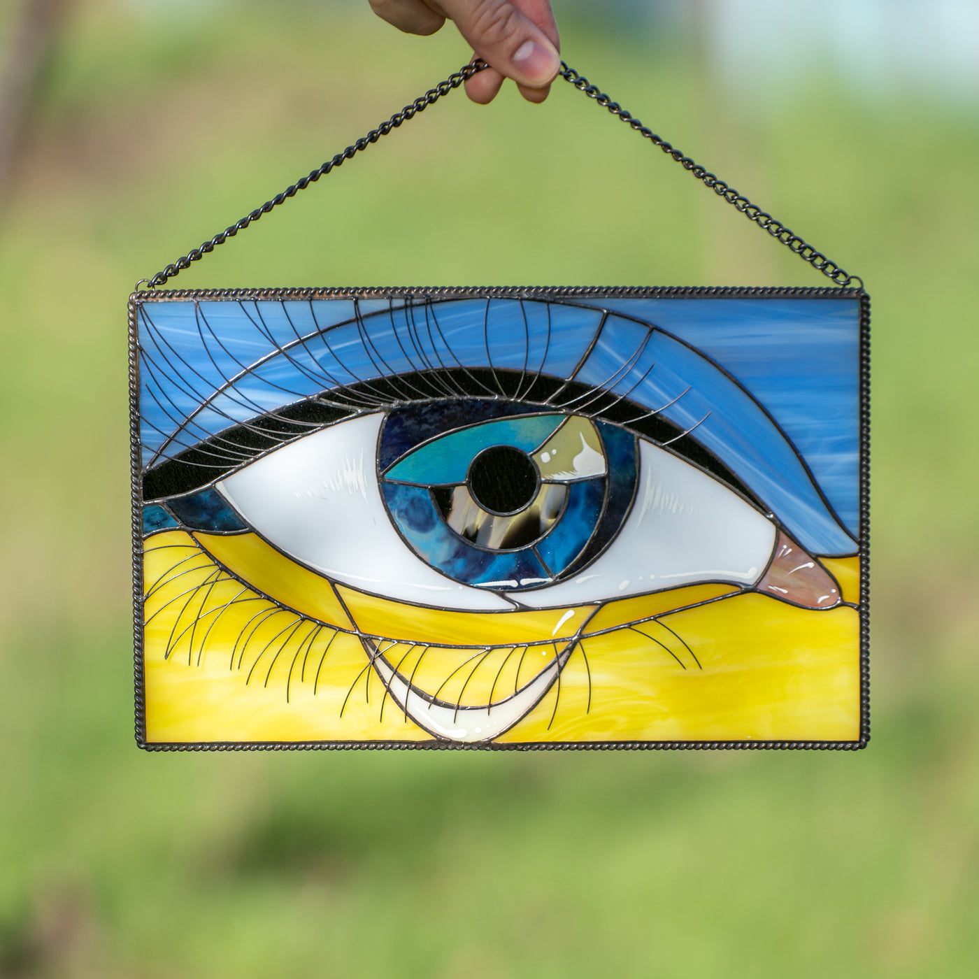 Ukrainian flag with the crying eye in the middle window hanging of stained glass 