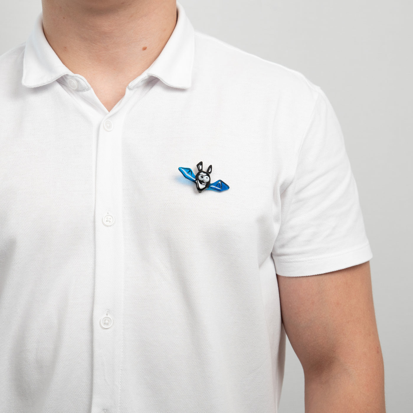 Stained glass blue bat brooch on a shirt