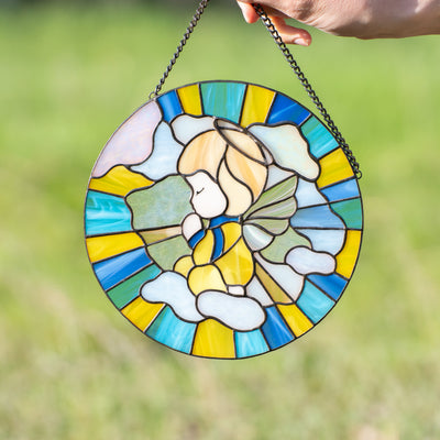 Stained glass window panel depicting angel on blue and yellow background