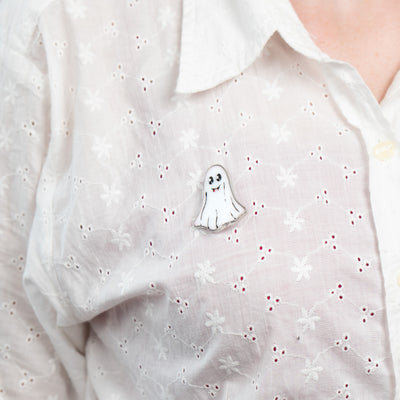 Stained glass Halloween ghost brooch on a white shirt