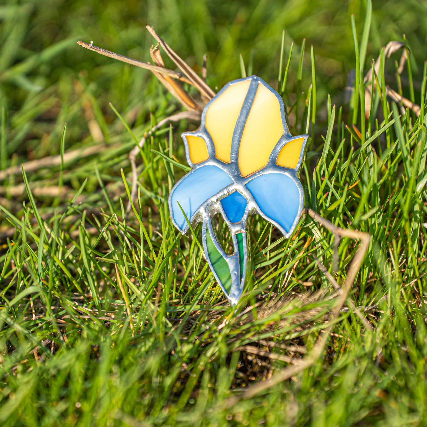 Stained glass handmade pin of blue and yellow iris