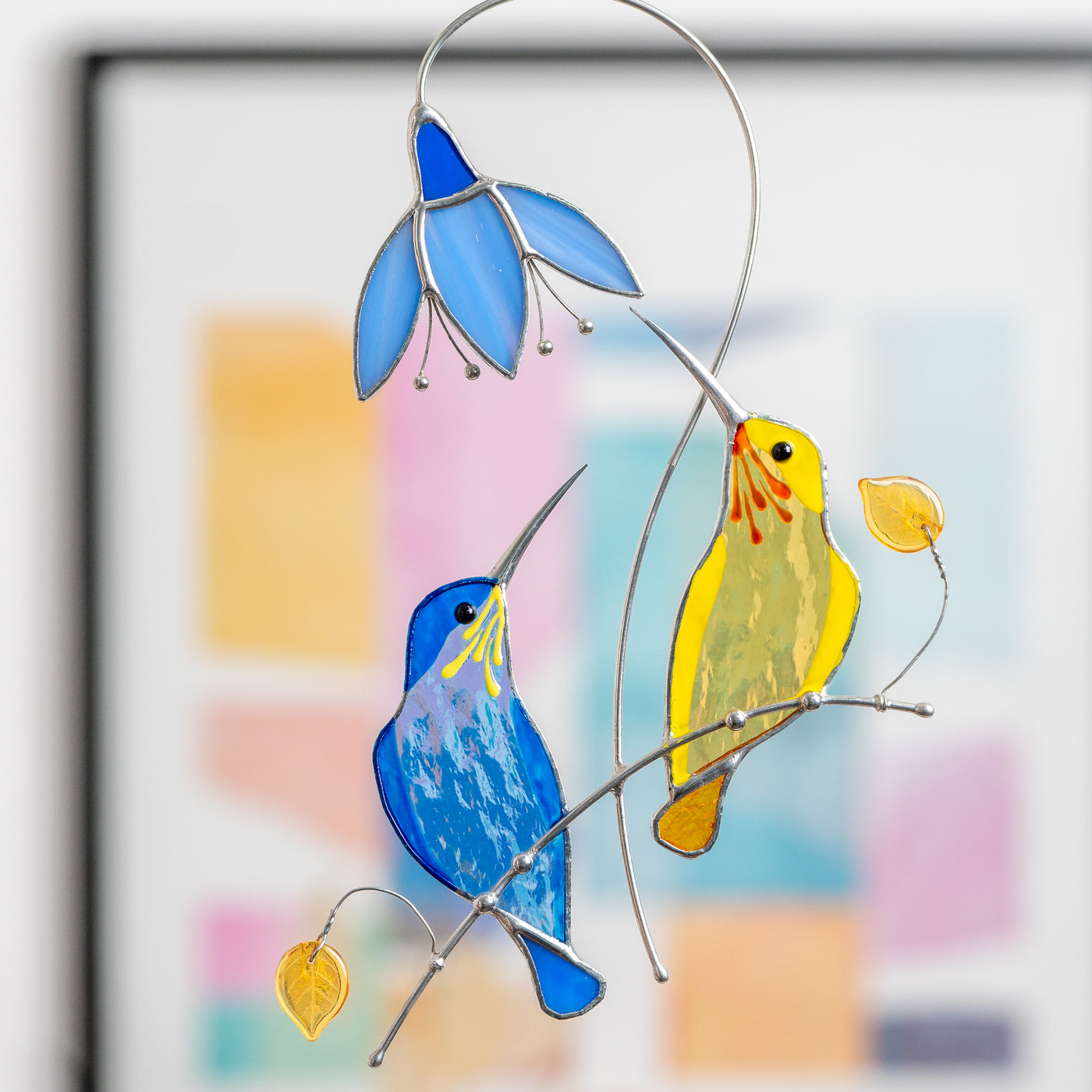 Zoomed stained glass blue and yellow hummingbirds window hanging 