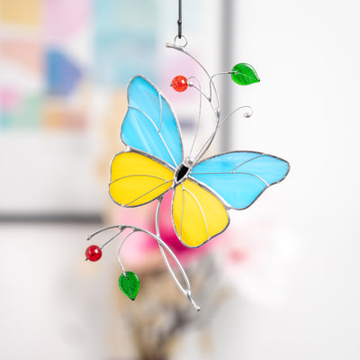 Stained glass window hanging of a butterfly with light blue and yellow wings