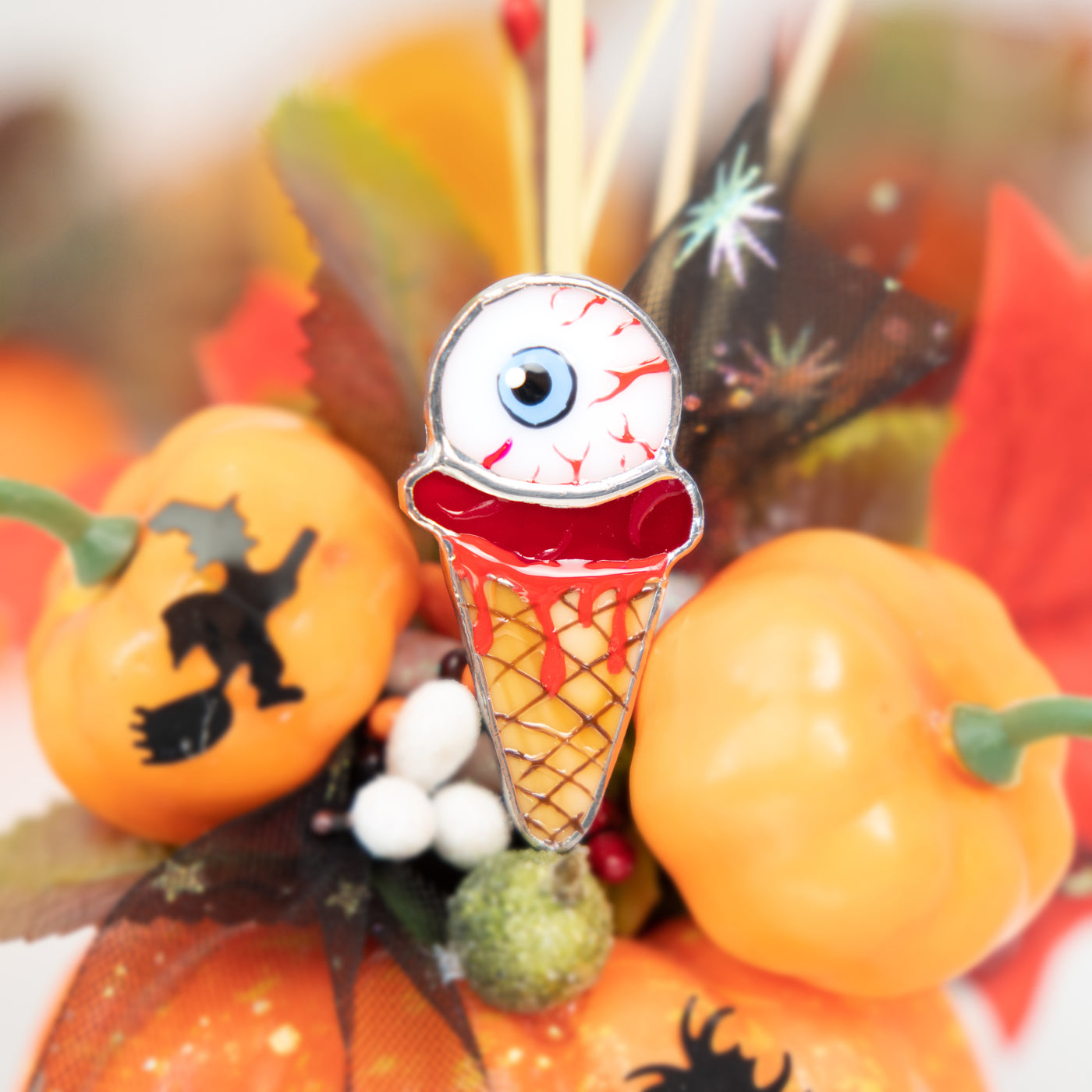 Halloween ice-cream with the torn out eye pin of stained glass