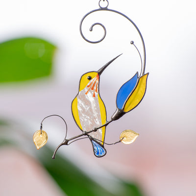 Yellow hummingbird with blue and yellow flower window hanging of stained glass