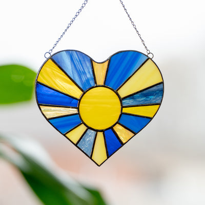 Stained glass suncatcher of Ukrainian heart with the sun-rays inside