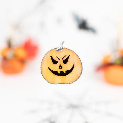 Stained glass pin of a spooky smiling halloween pumpkin