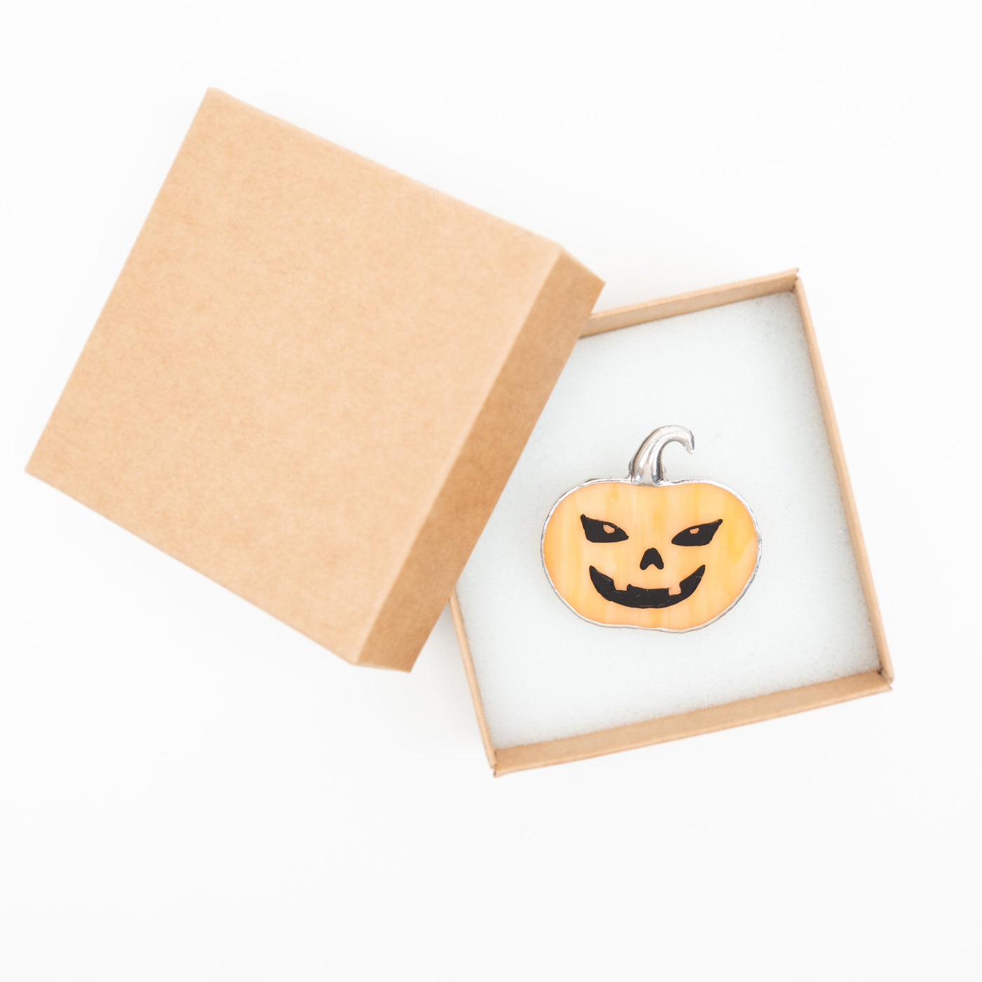 Smiling with teeth pumpkin pin in a brand box