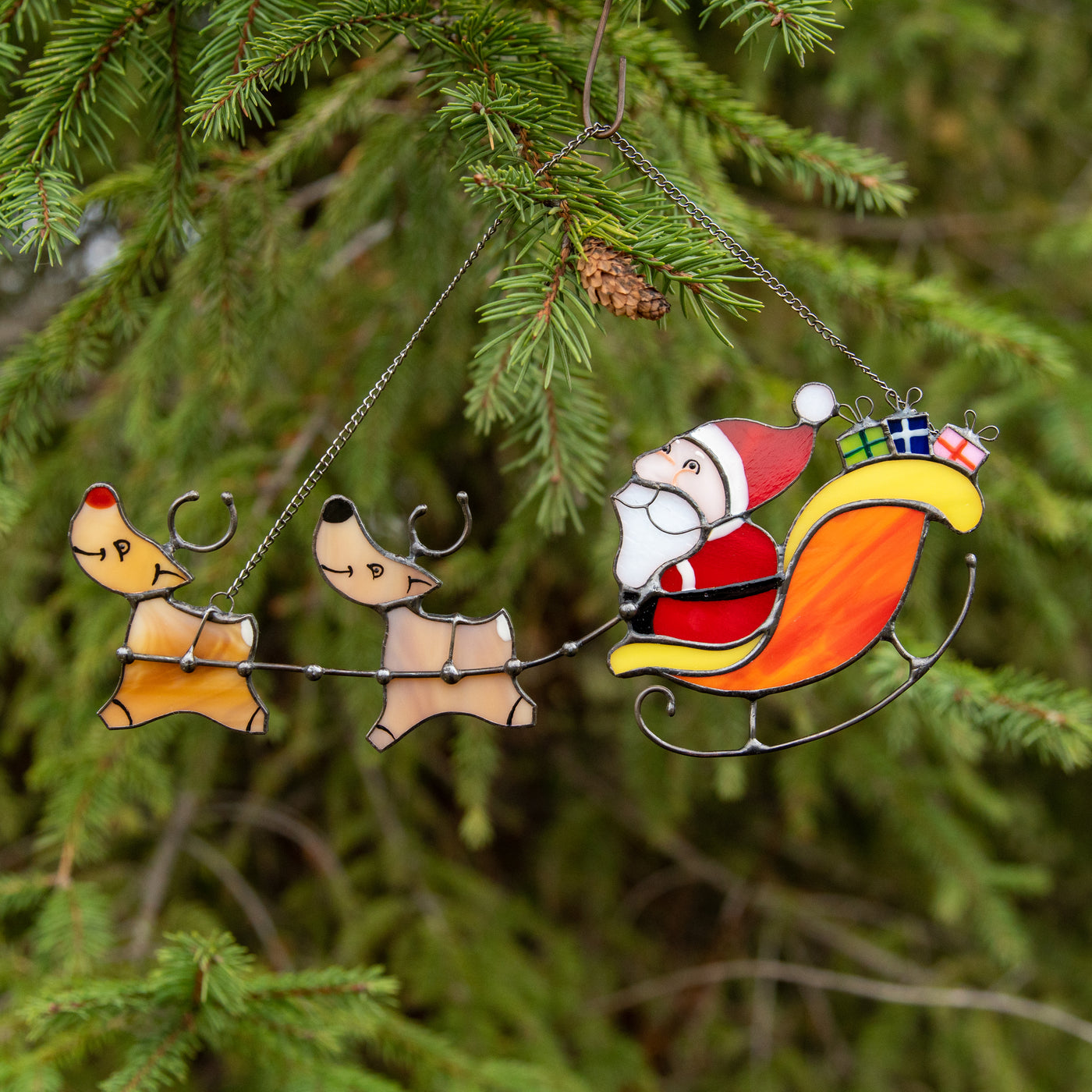 Stained glass Santa's reindeer team suncatcher used as a New Year Tree decoration