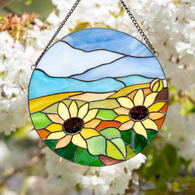 Stained glass panel depicting sunflowers and blue skies for window decor