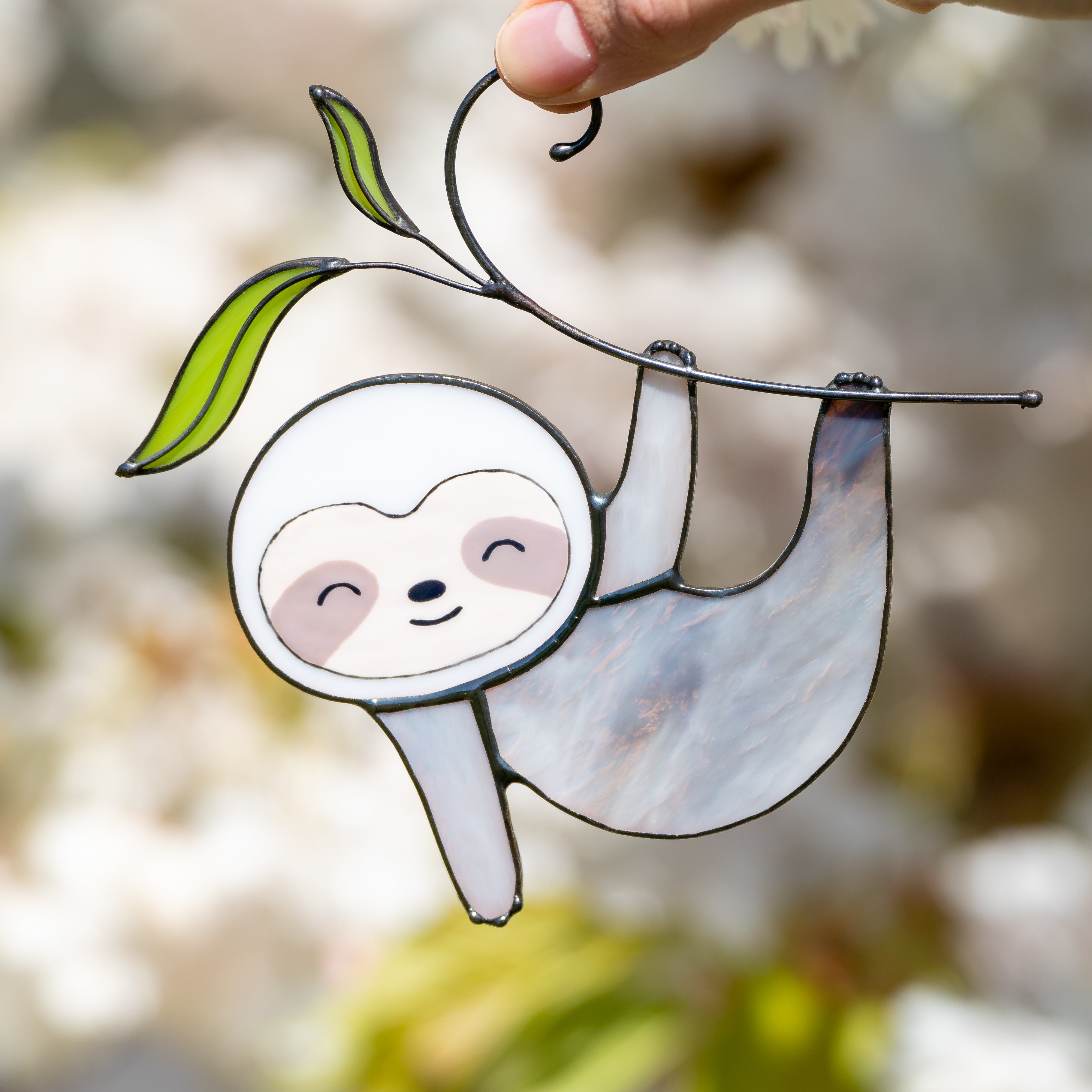 Stained glass sloth on the branch with leaves sucncatcher