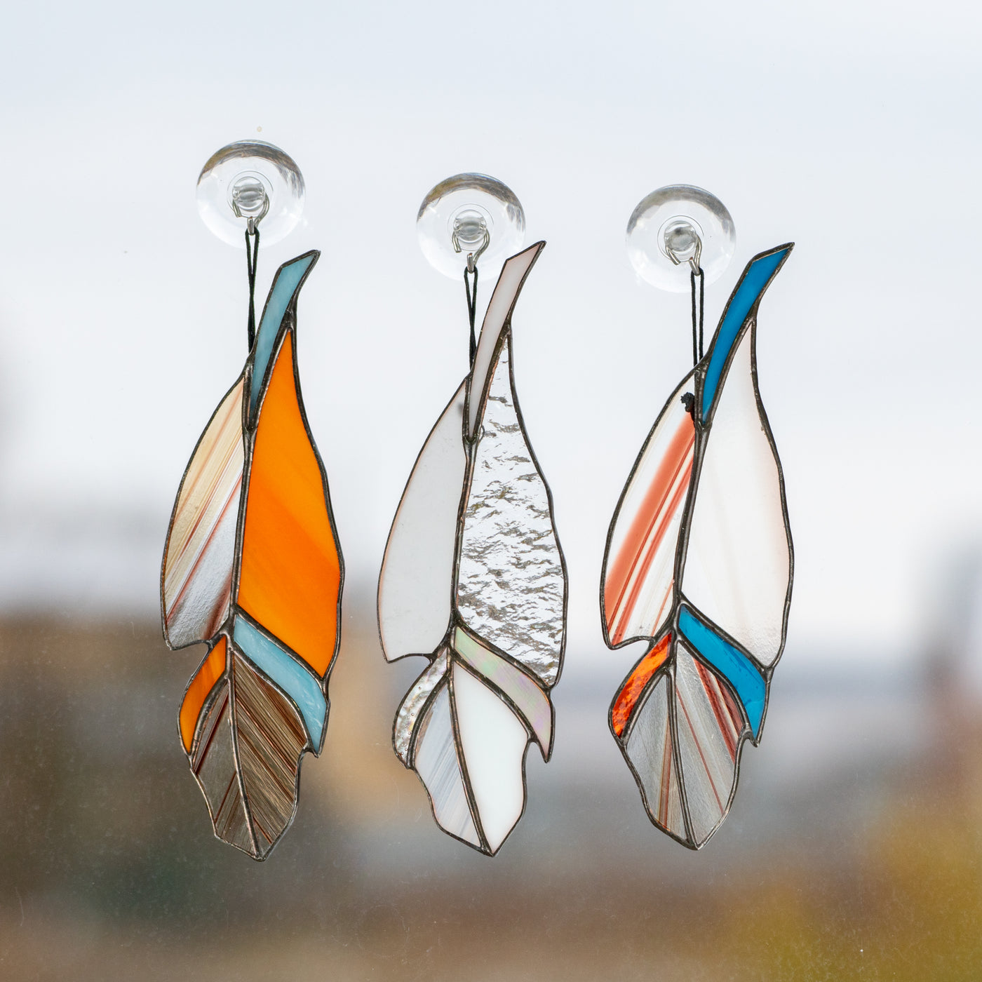 Three stained glass clear feathers suncatchers