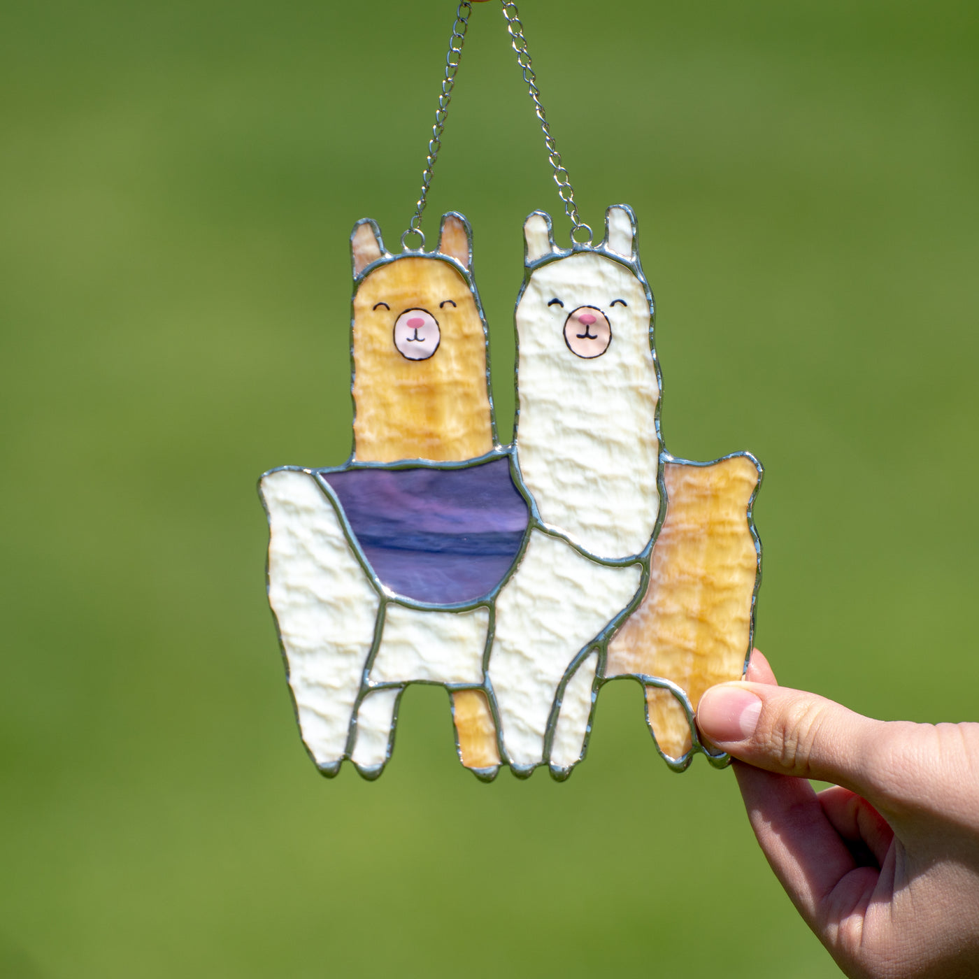 Couple of white and orange llamas standing across each other suncatcher of stained glass