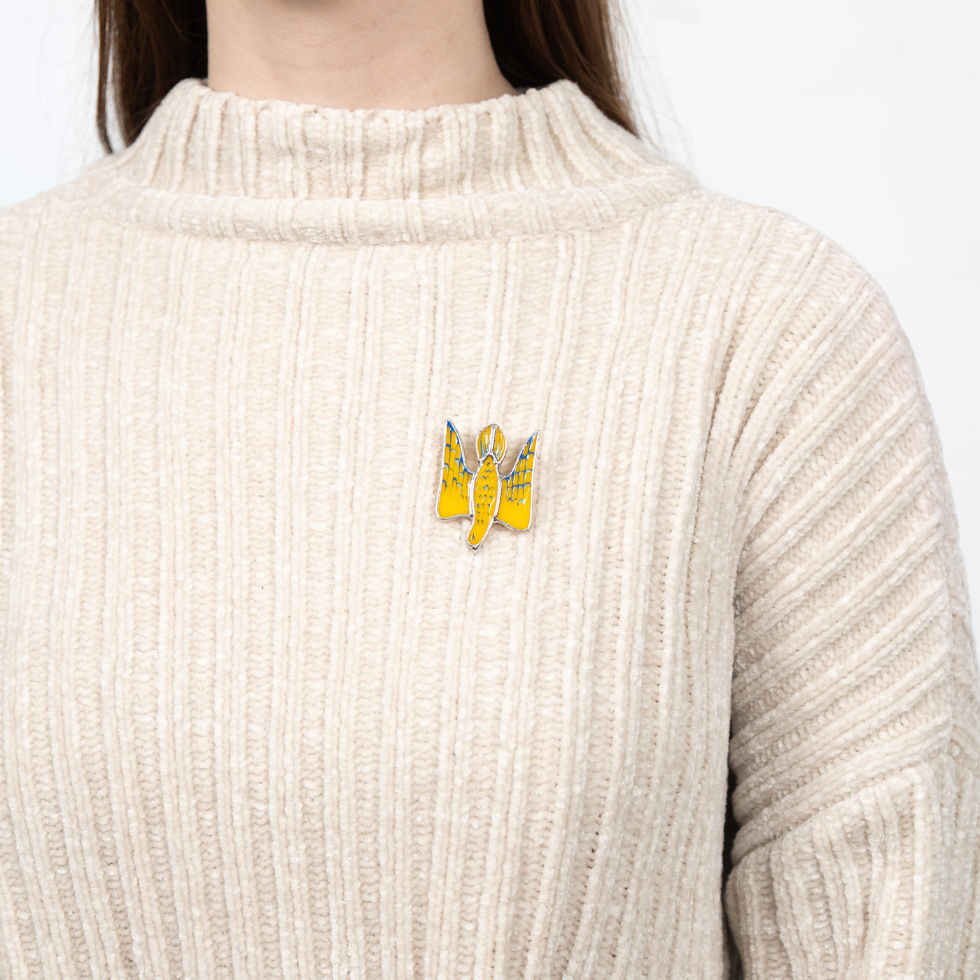 Stained glass falcon brooch on a sweater