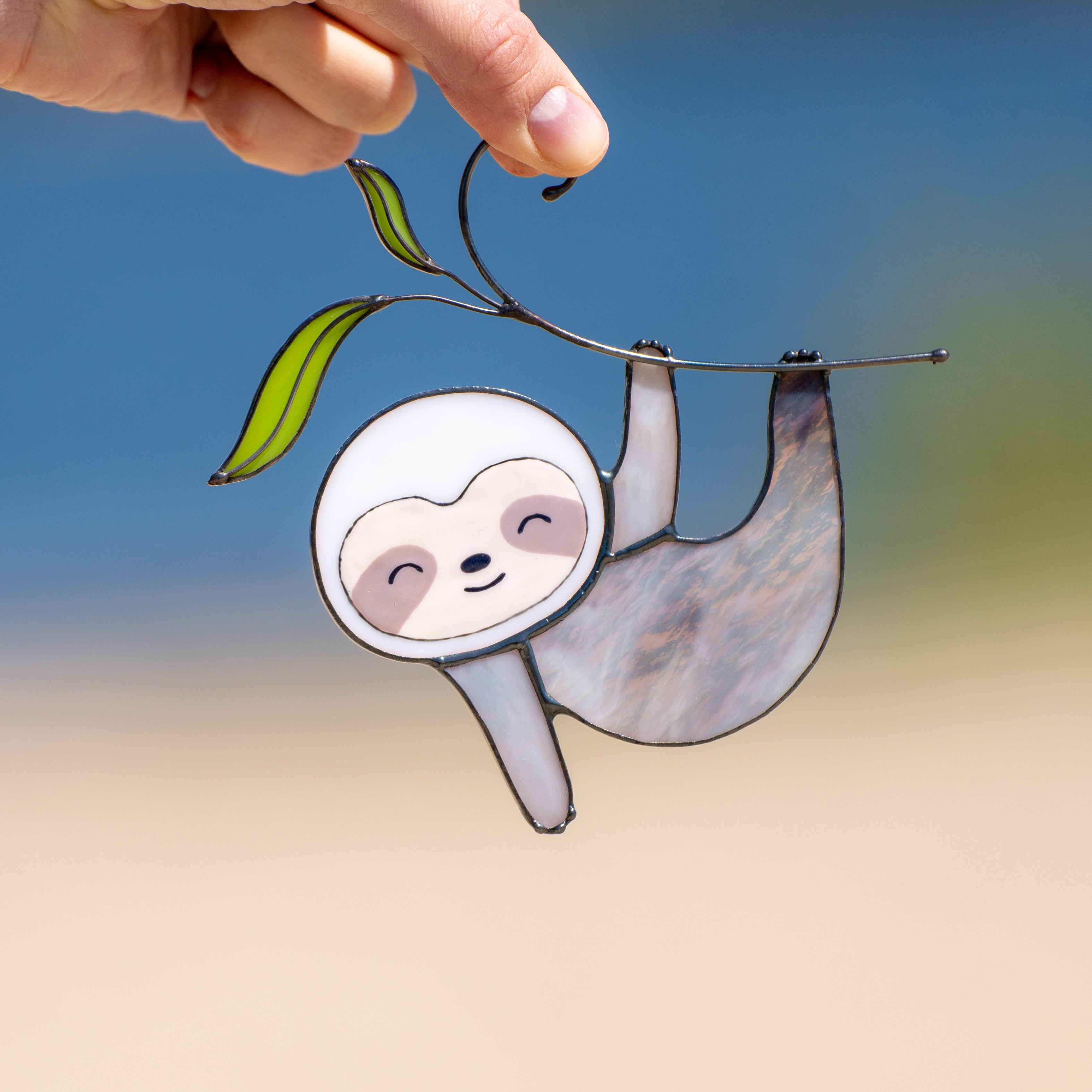 Swinging sloth on the branch suncatcher of stained glass