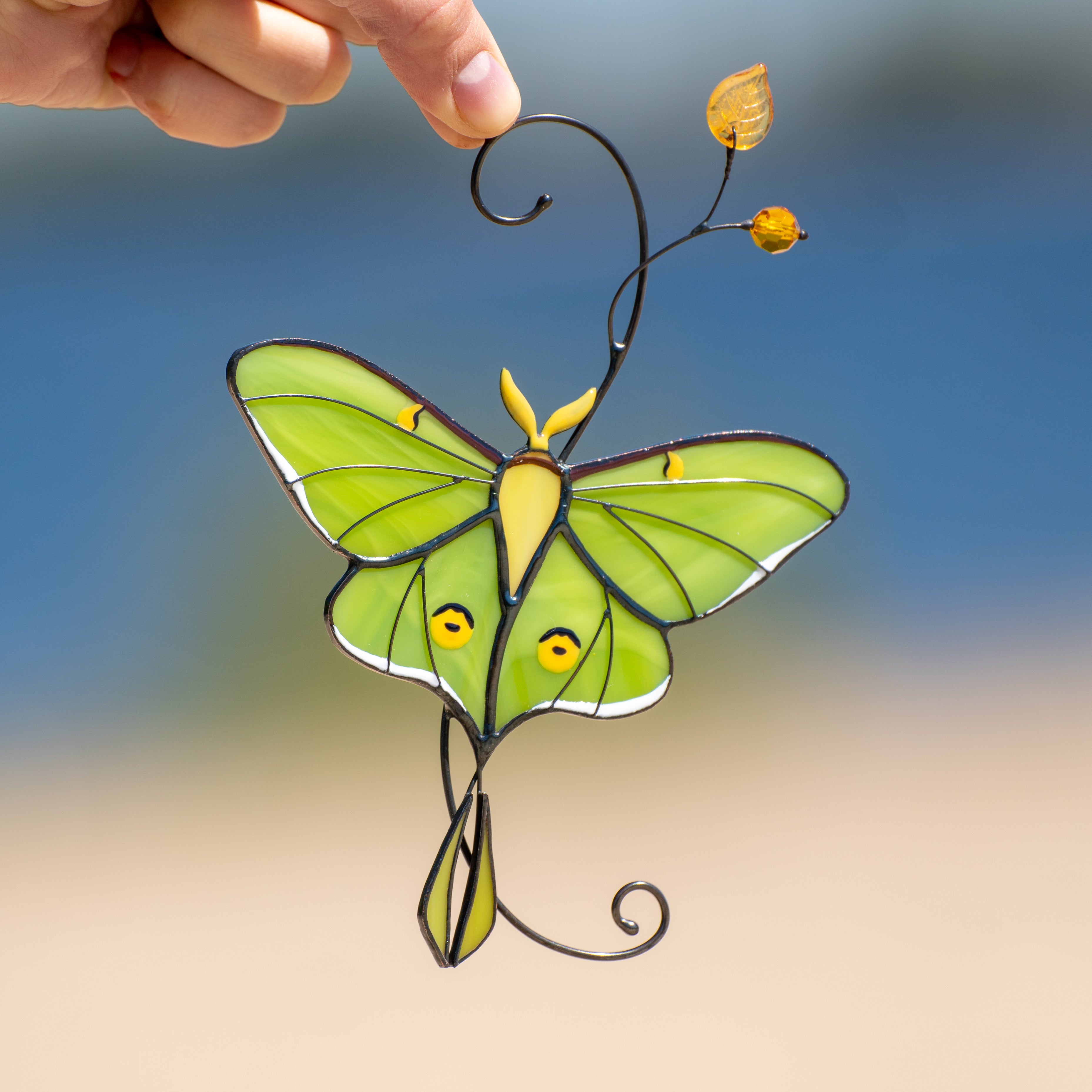 Green luna moth window hanging of stained glass