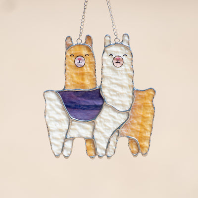 Two llamas standing across each other suncatcher of stained glass