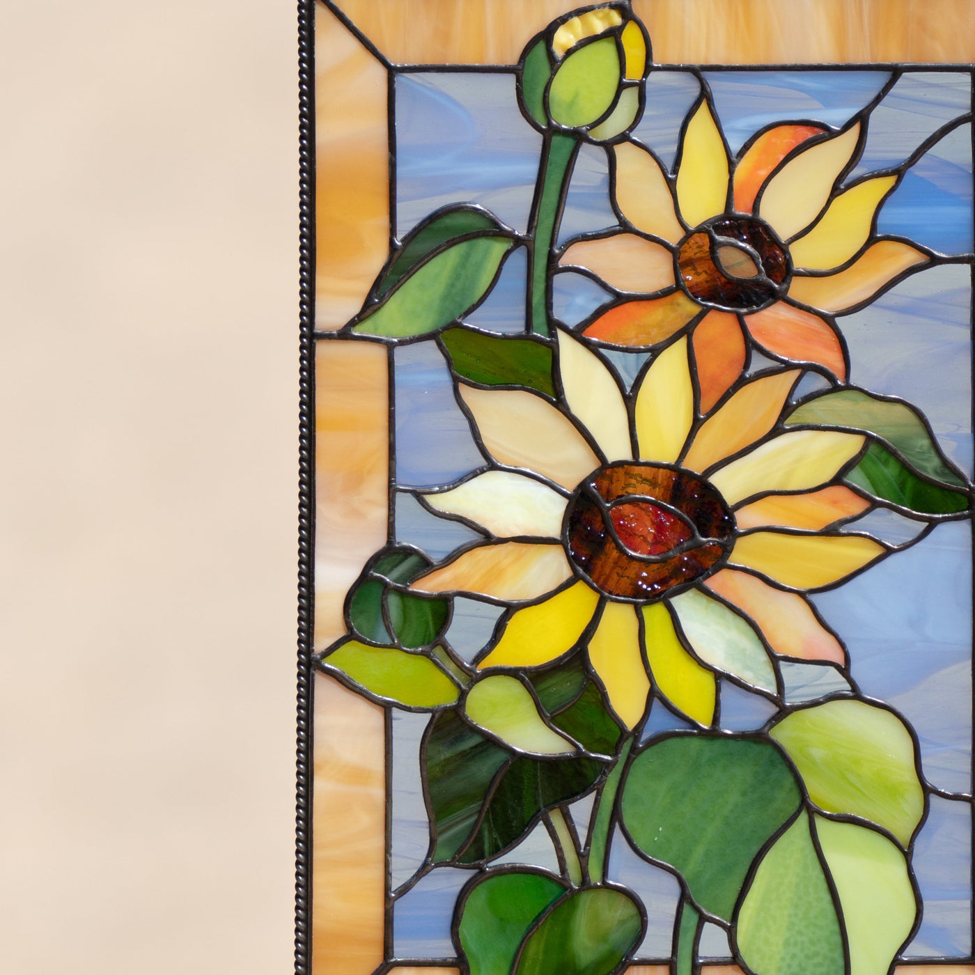 Zoomed stained glass window hanging depicting sunflowers