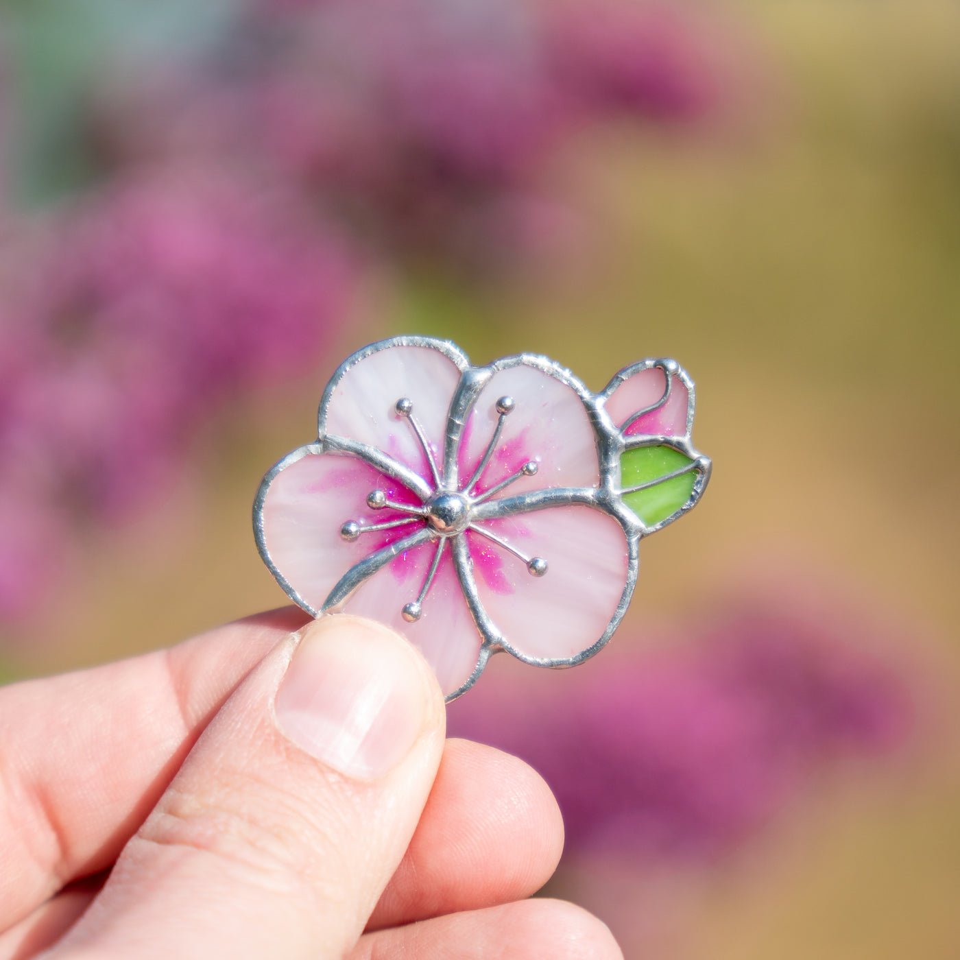 Stained glass apricot blossom flower with a green leaf brooch