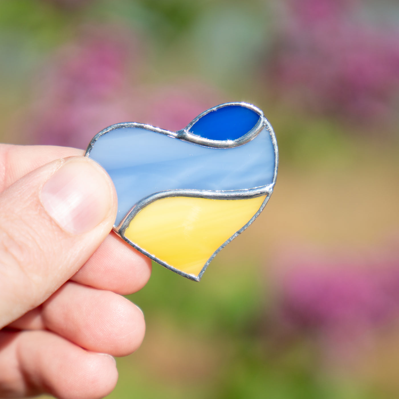 Ukrainian heart brooch with light blue in the middle and royal blue above of stained glass
