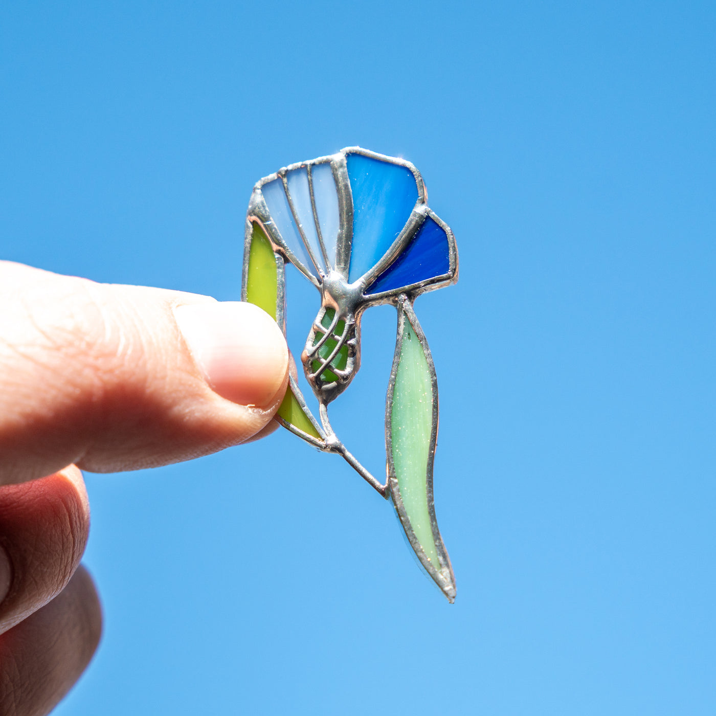 Stained glass handmade brooch of a  blue and navy cornflower 