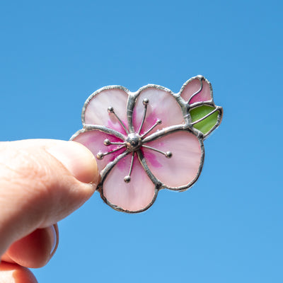 Stained glass pin of an apricot blossom flower