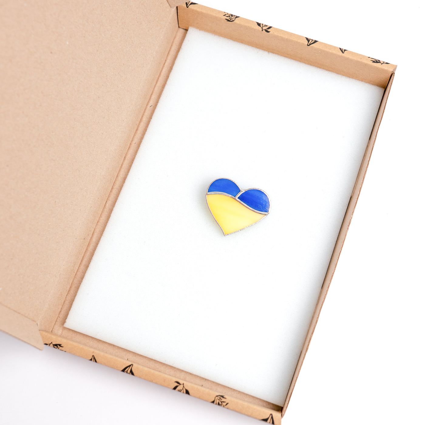 Stained glass dark-blue and yellow heart pin in a brand box